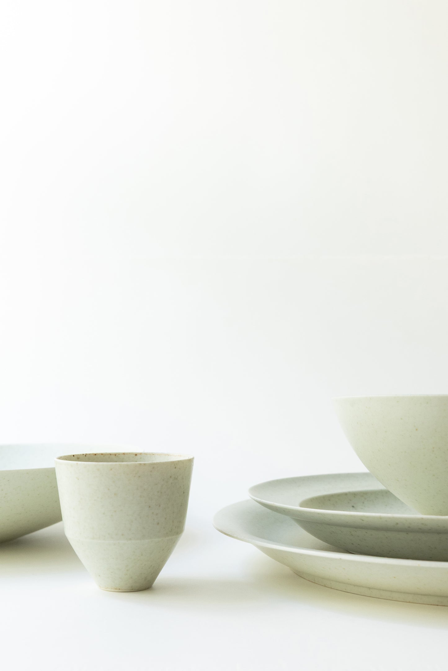 Set of white ceramic bowls on a light background