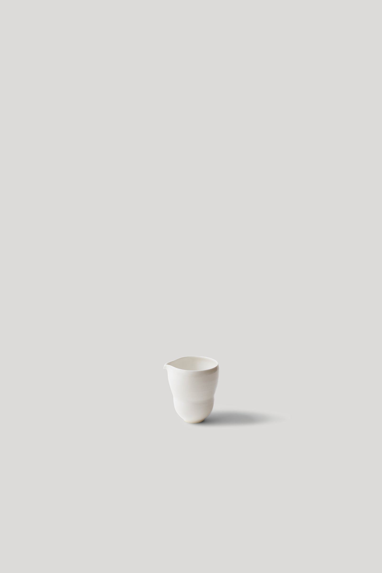 White ceramic cup on a light gray background
