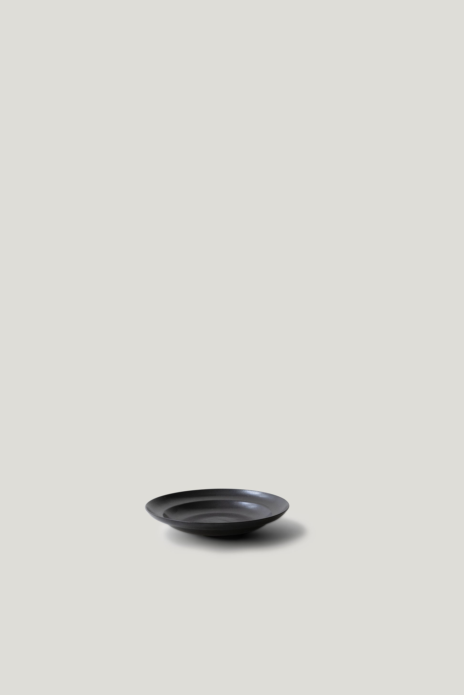 Black ceramic bowl on a light gray background