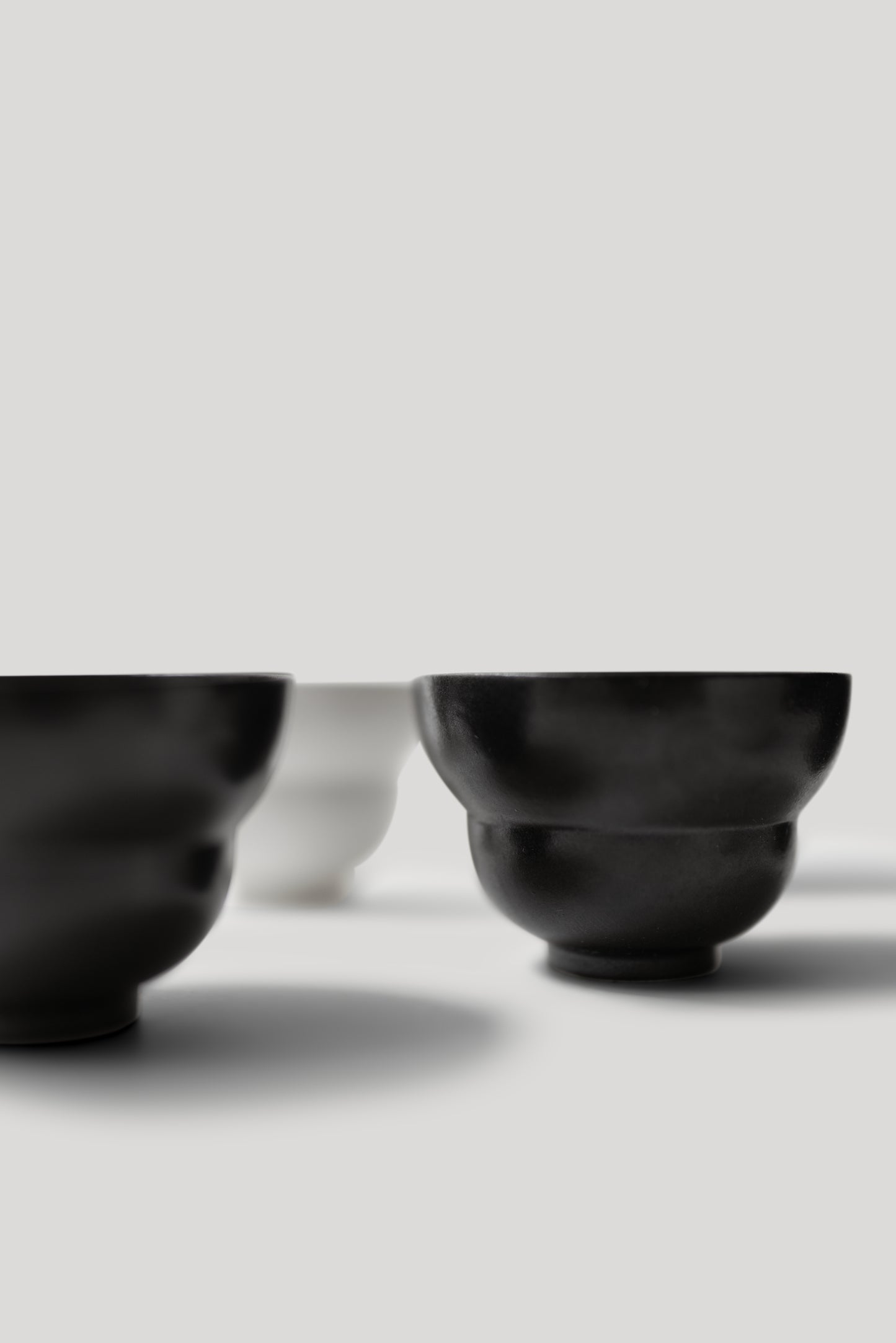 Close-up of black and white shoes on a light gray background