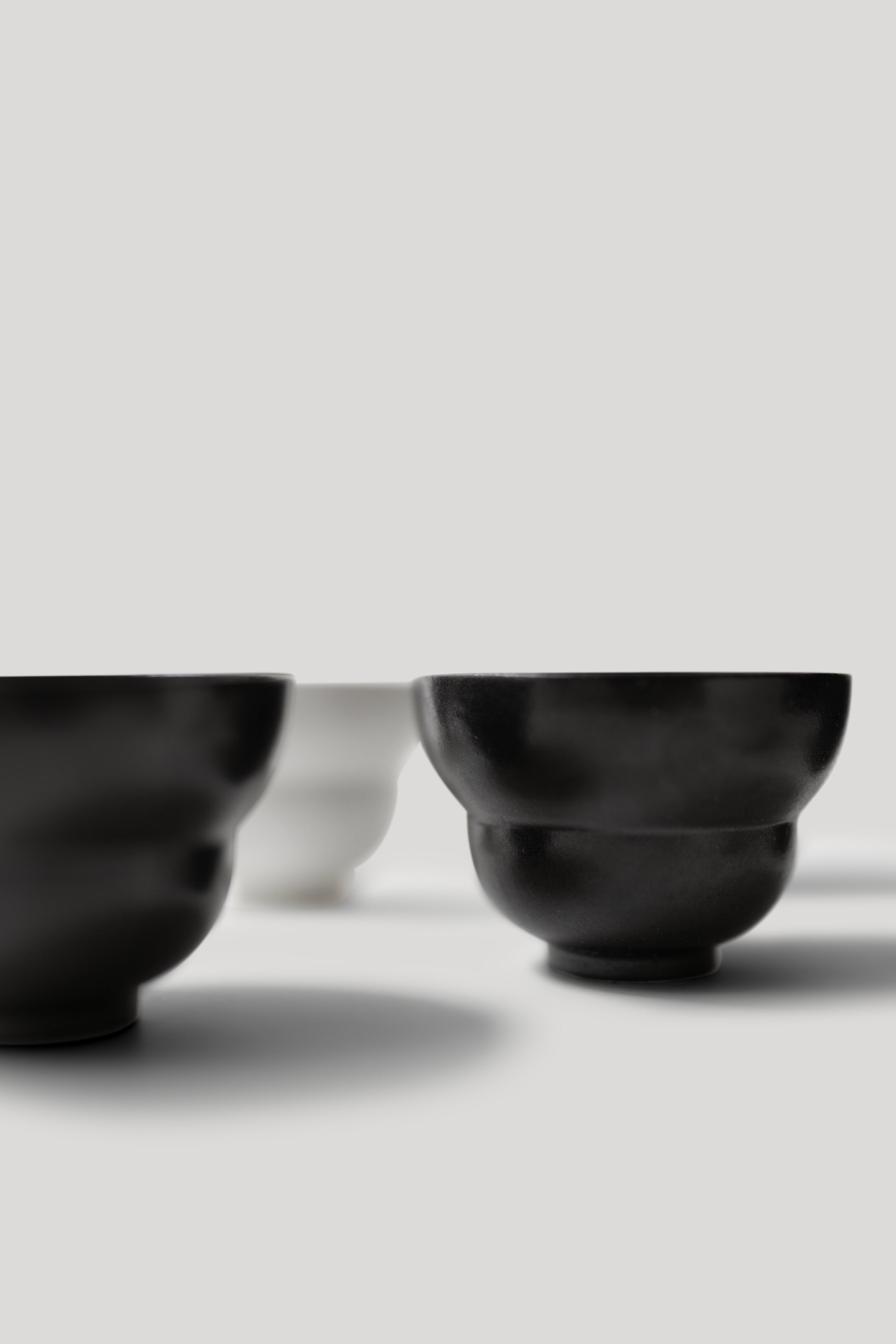 Close-up of black and white shoes on a light gray background