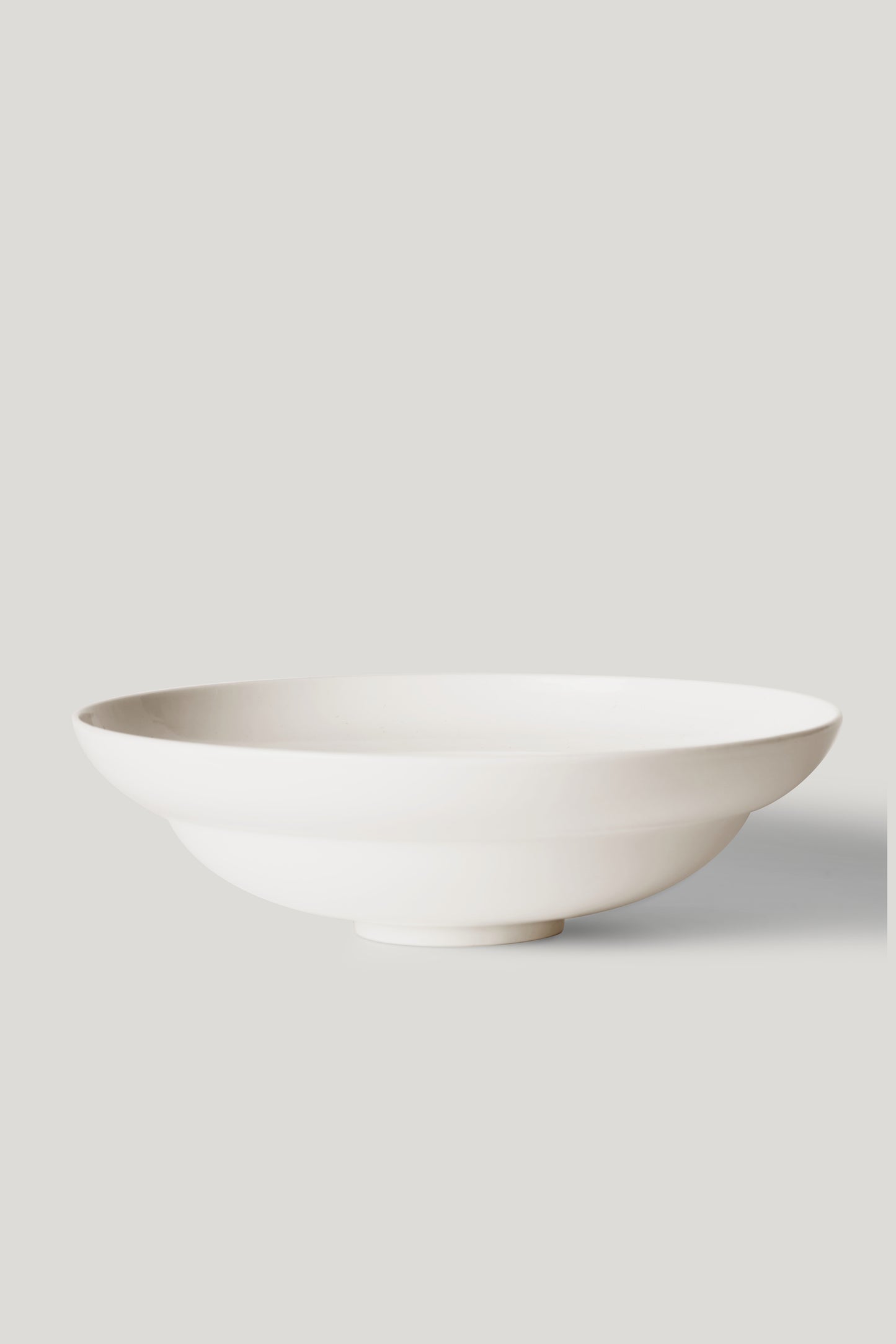 White ceramic bowl on a light gray background