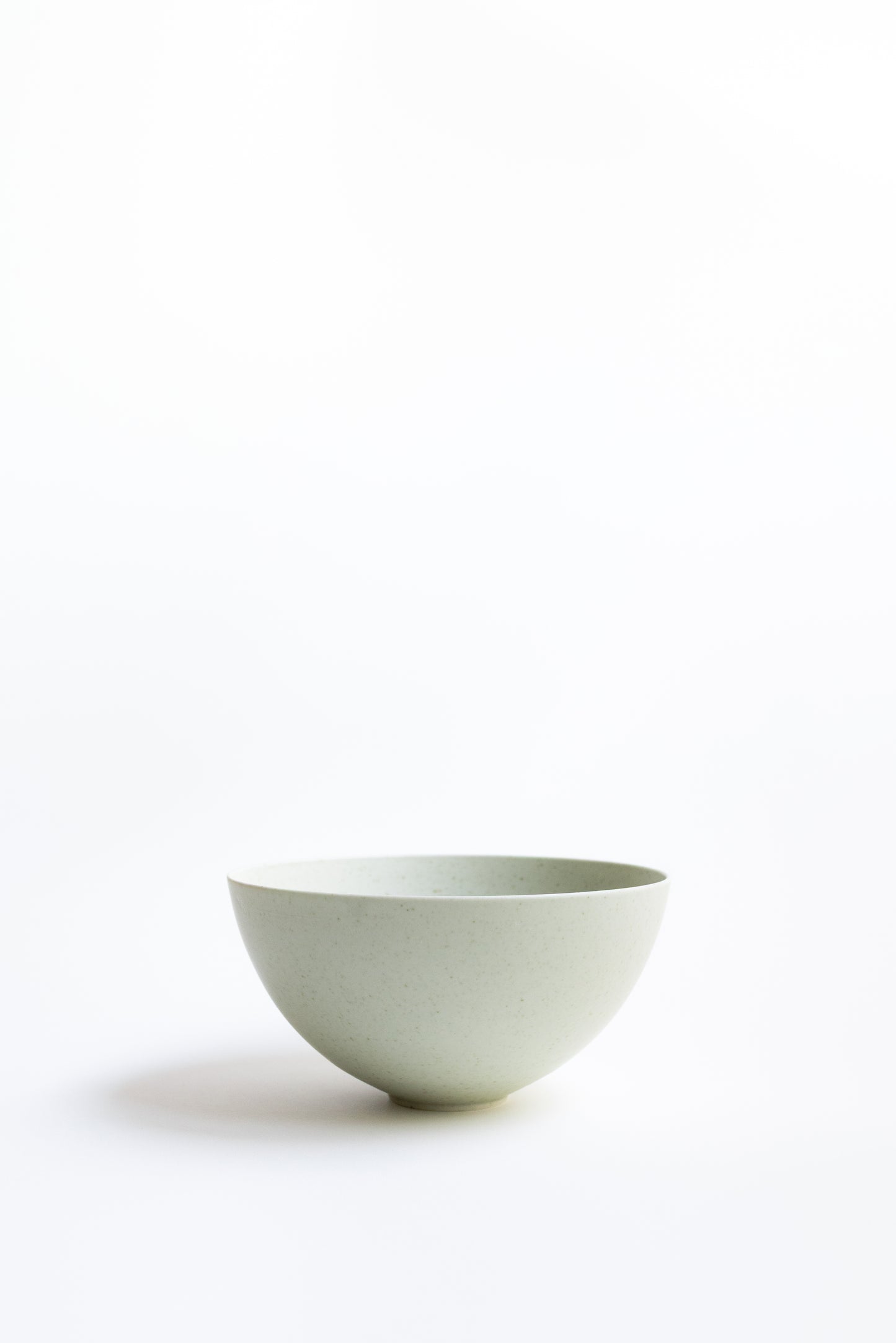 Light green ceramic bowl on a white background