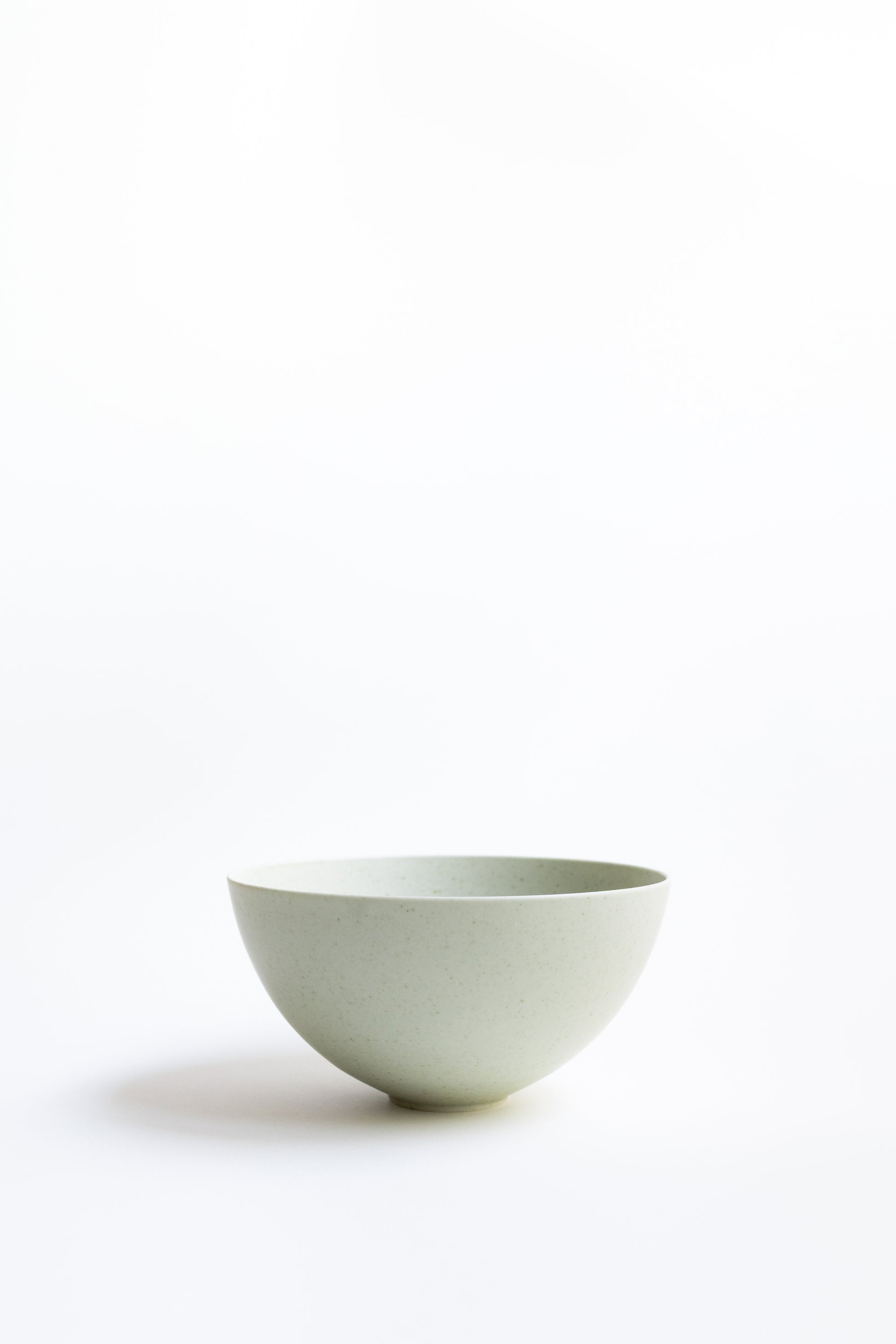 Light green ceramic bowl on a white background