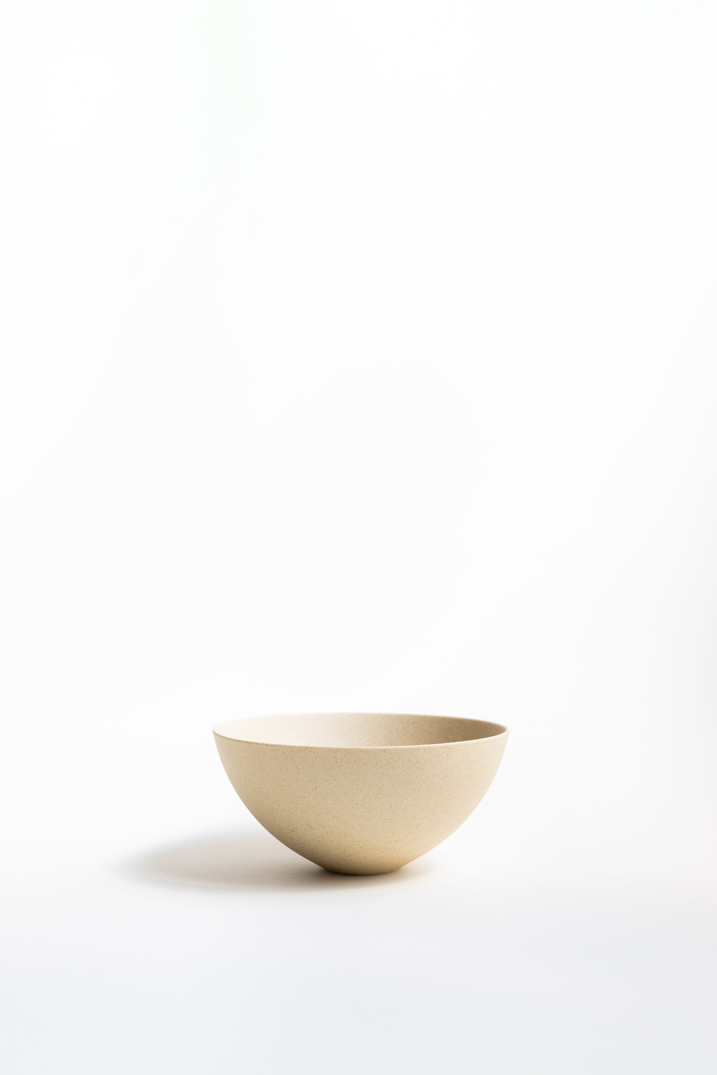 Beige ceramic bowl on a white background
