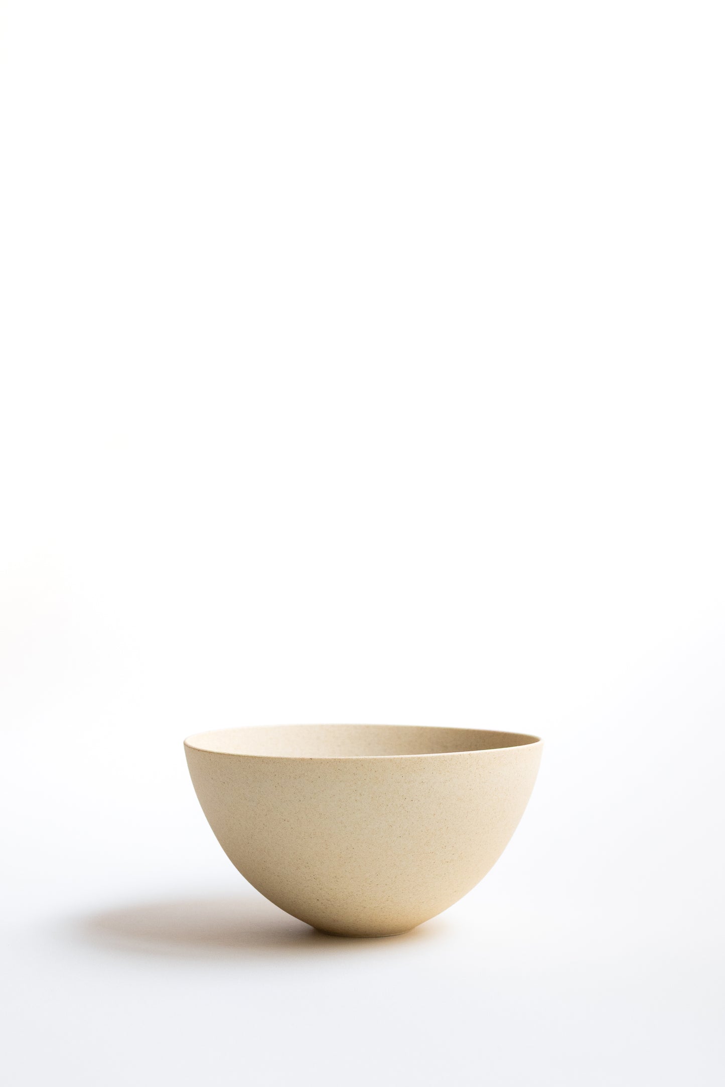 Beige ceramic bowl on a white background