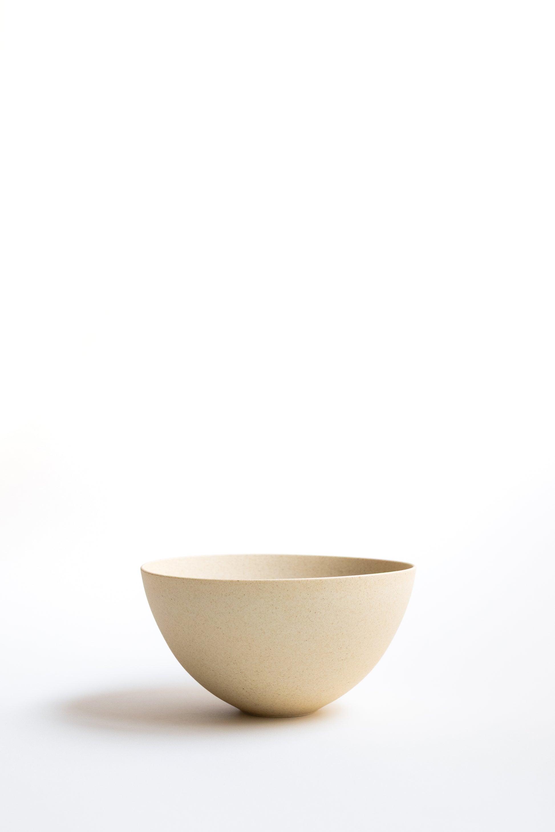 Beige ceramic bowl on a white background