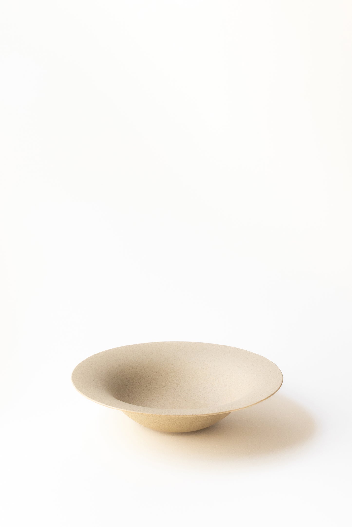 Beige ceramic bowl on a white background