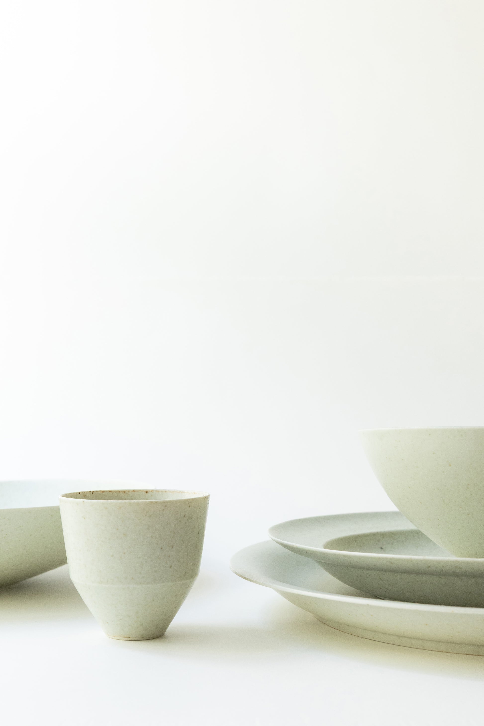Set of white ceramic bowls on a light background