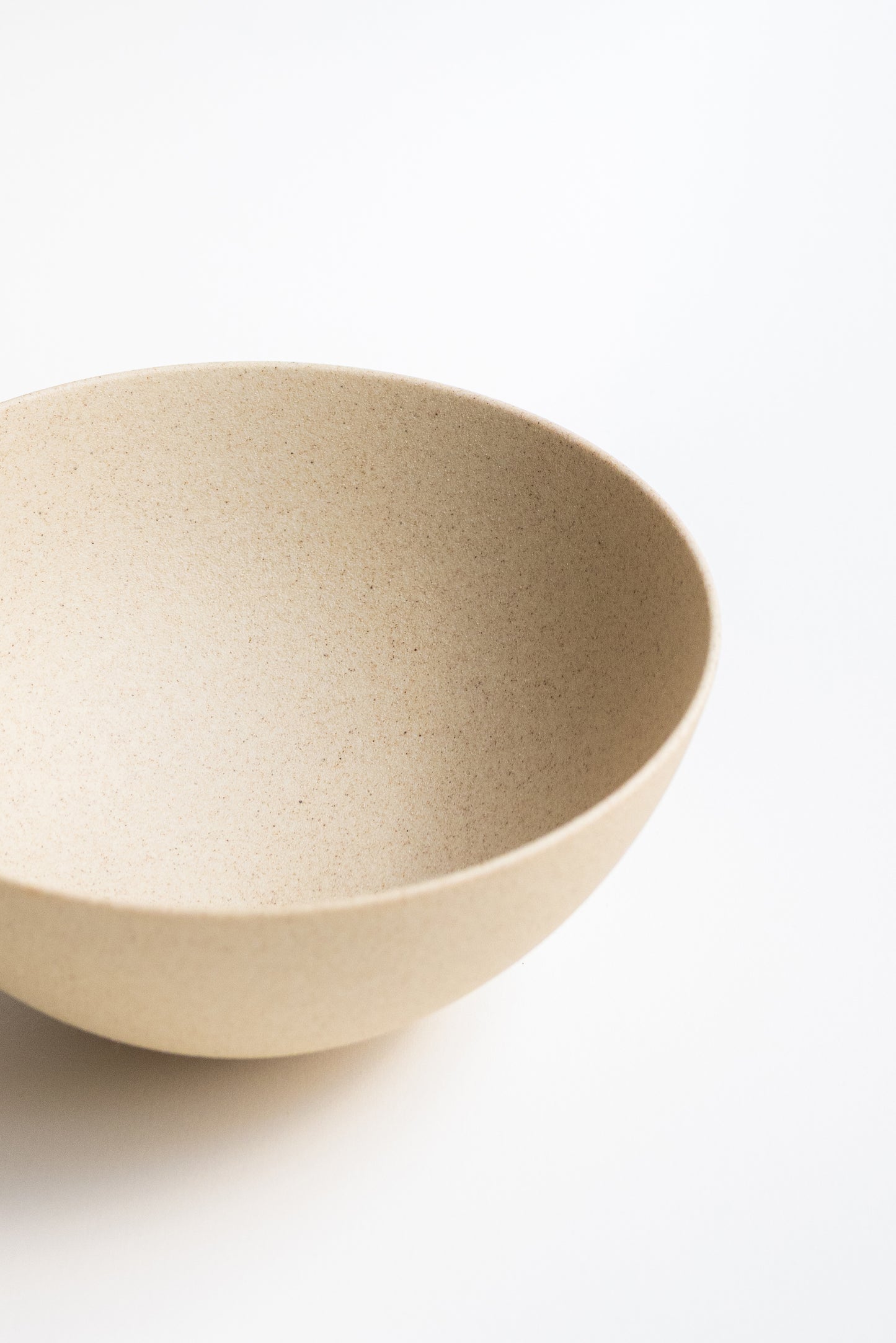 Beige ceramic bowl on a white background
