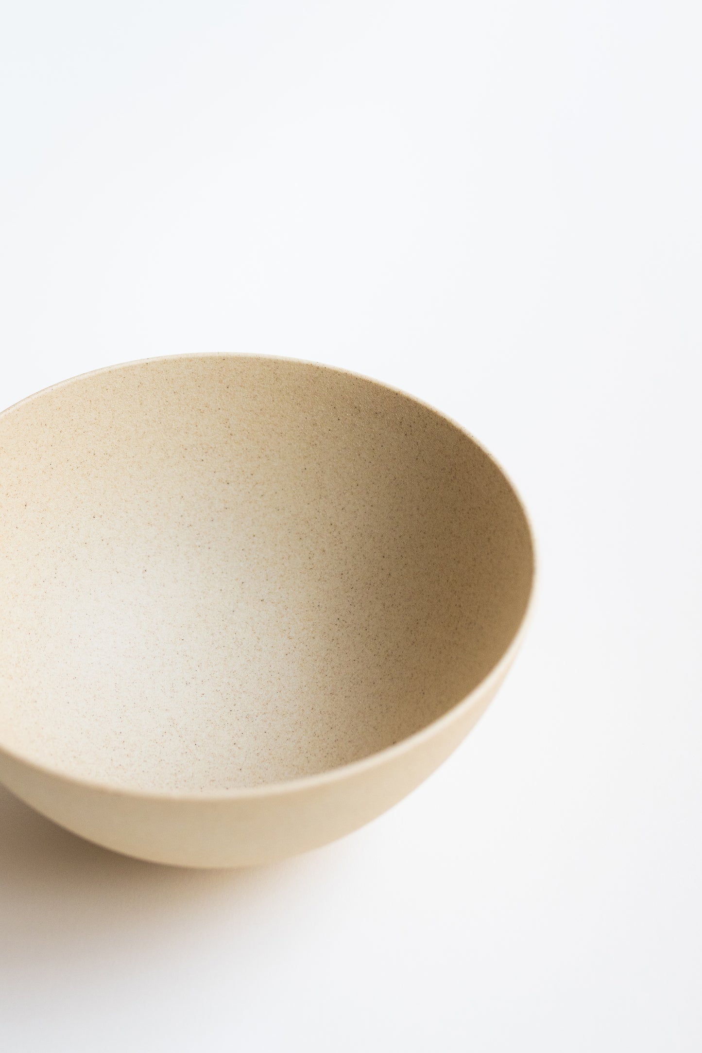 Beige ceramic bowl on a white background