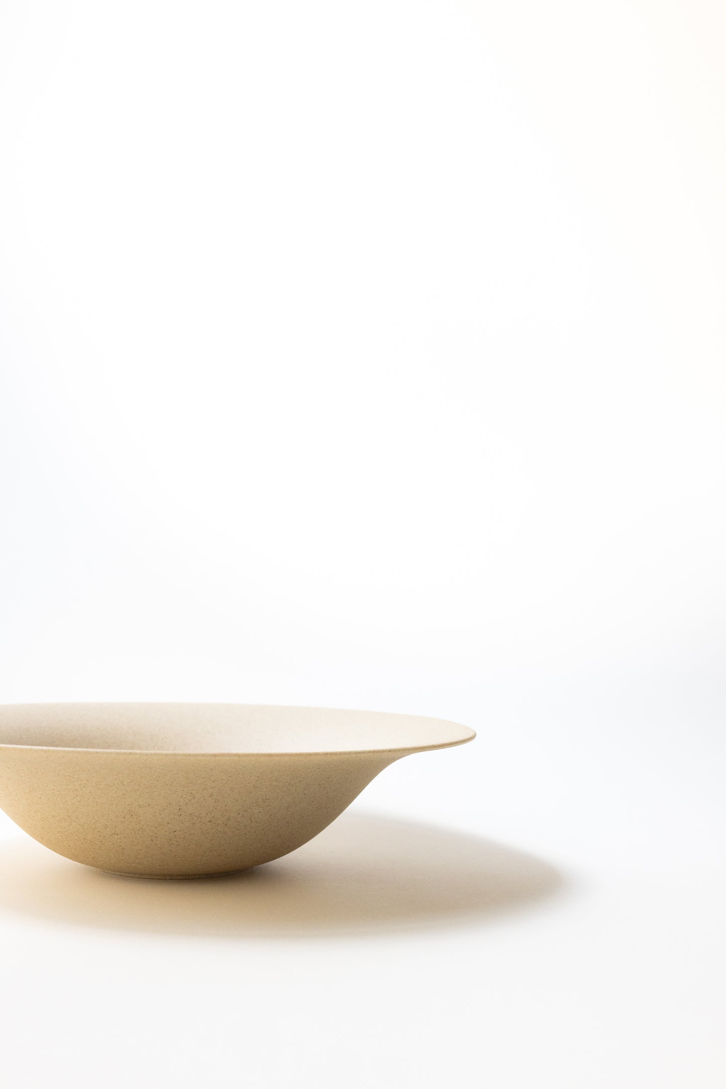 Beige ceramic bowl on a white background