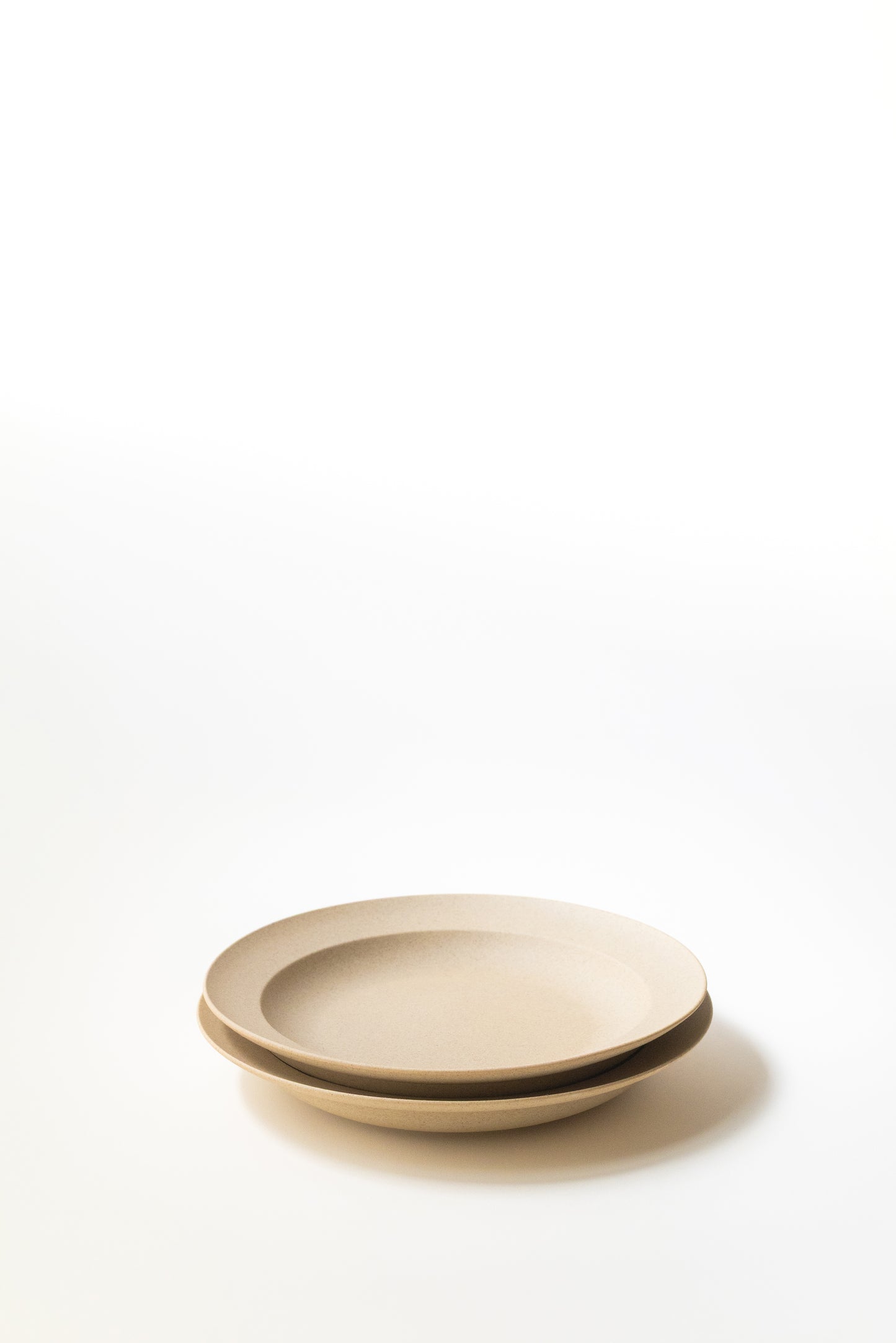 Beige ceramic plate on a white background