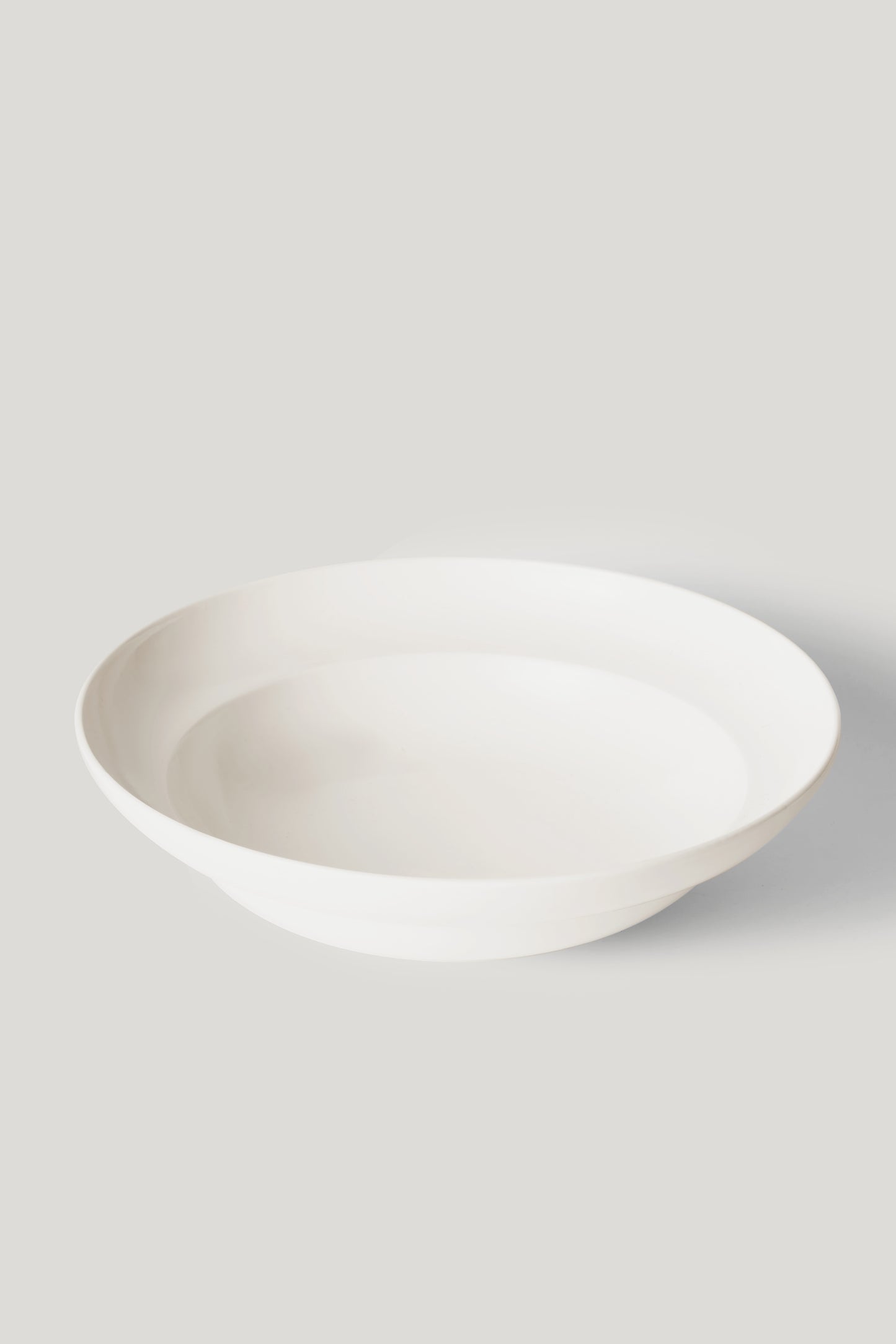 White ceramic bowl on a light gray background