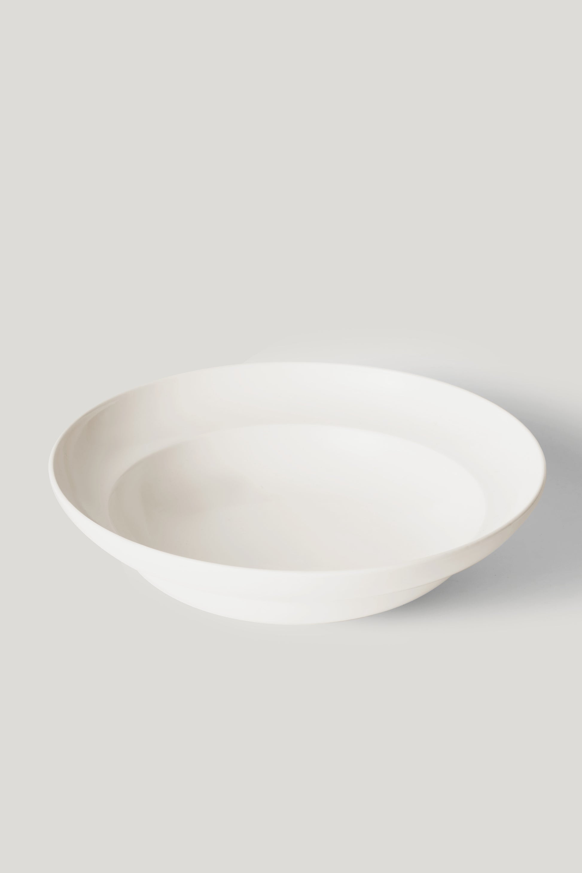 White ceramic bowl on a light gray background