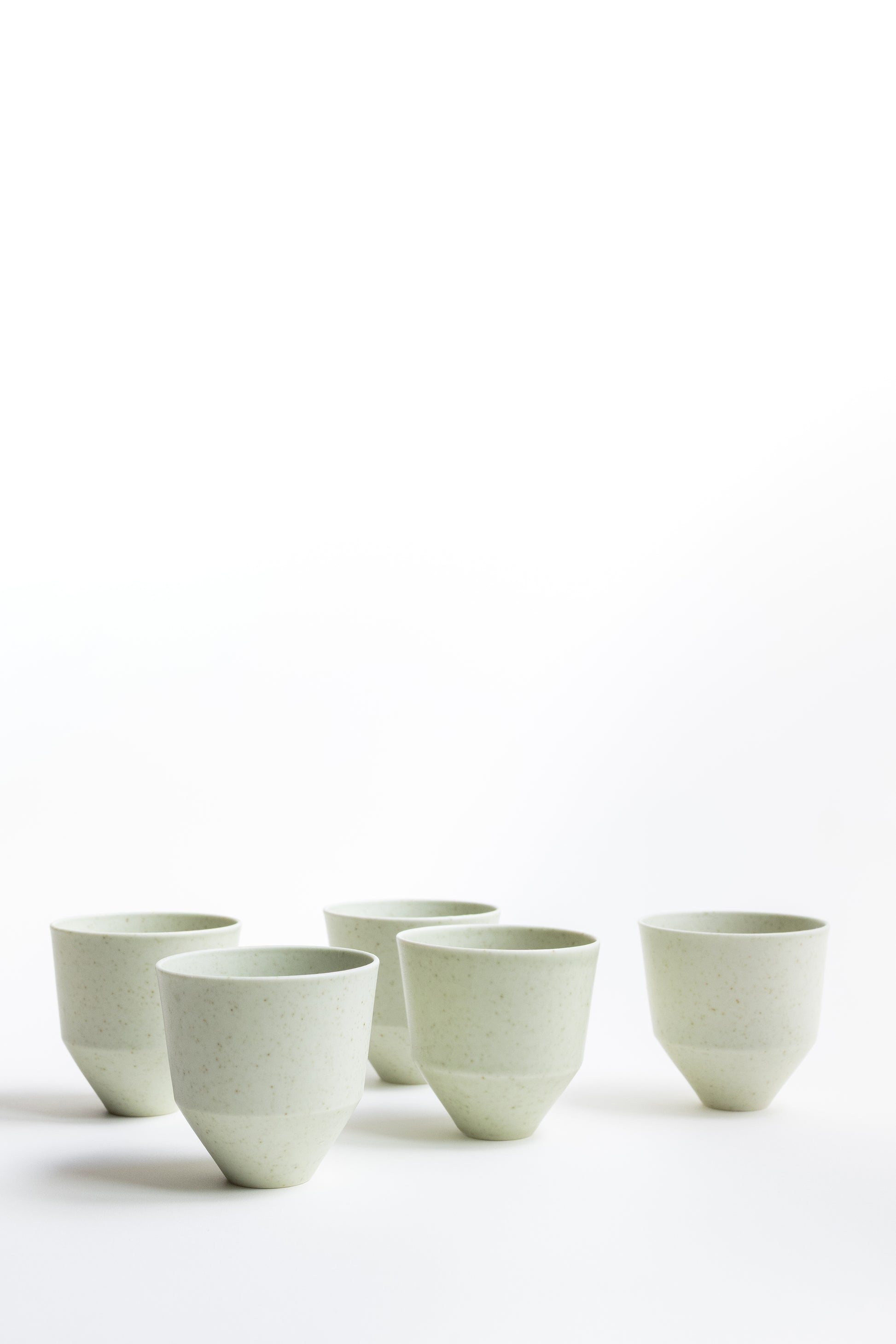 Set of six ceramic cups on a white background