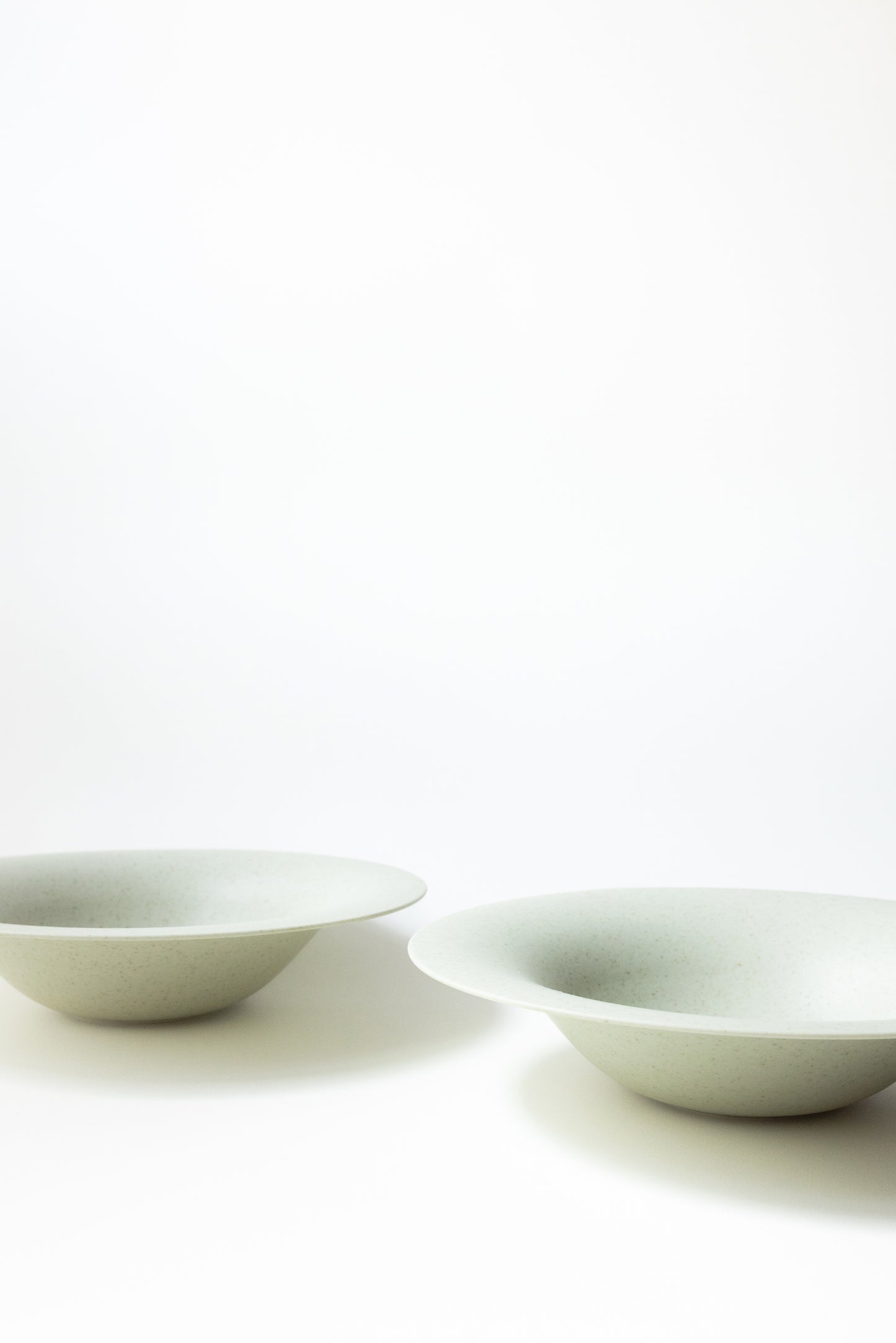 Two white ceramic bowls on a white background