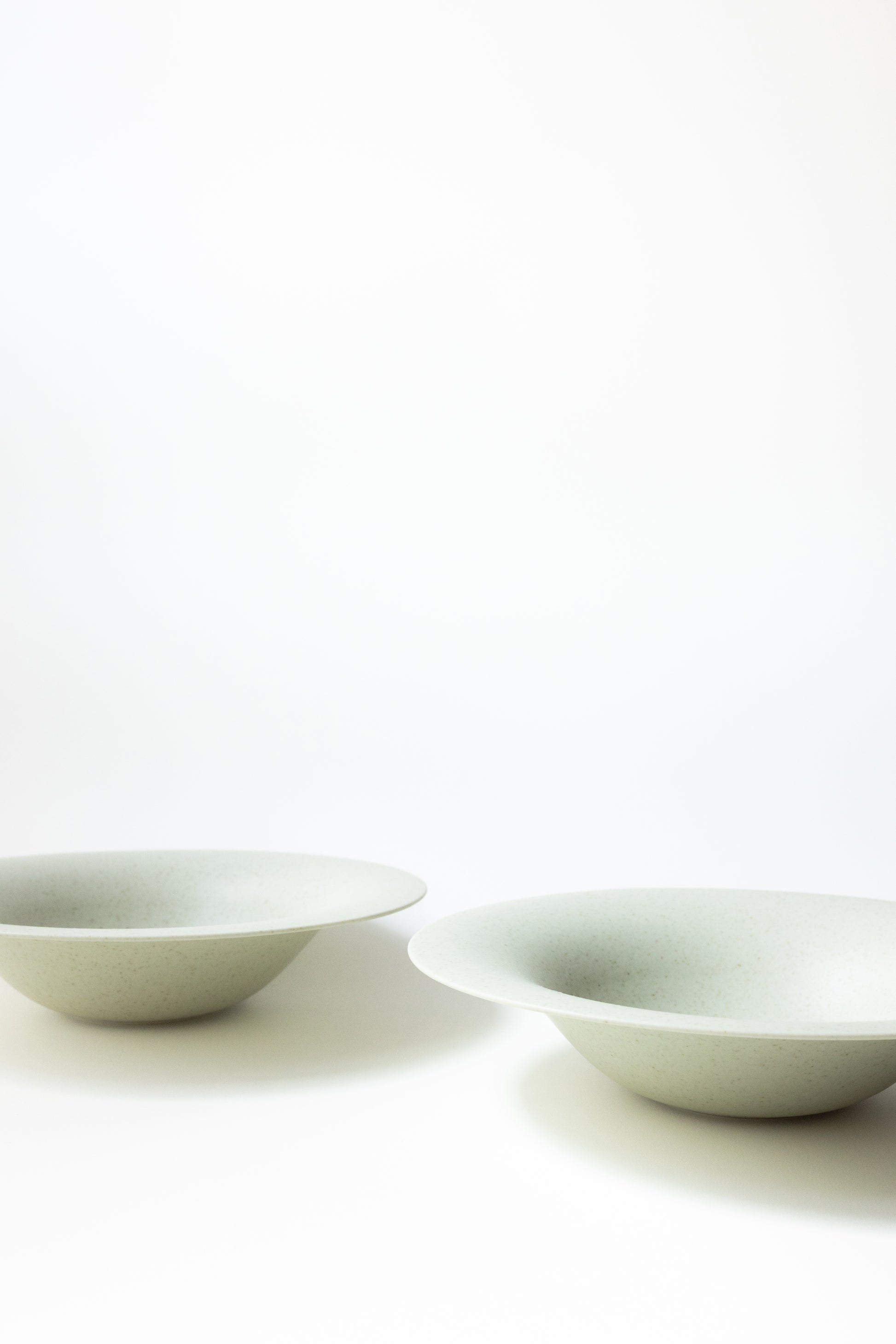 Two white ceramic bowls on a white background