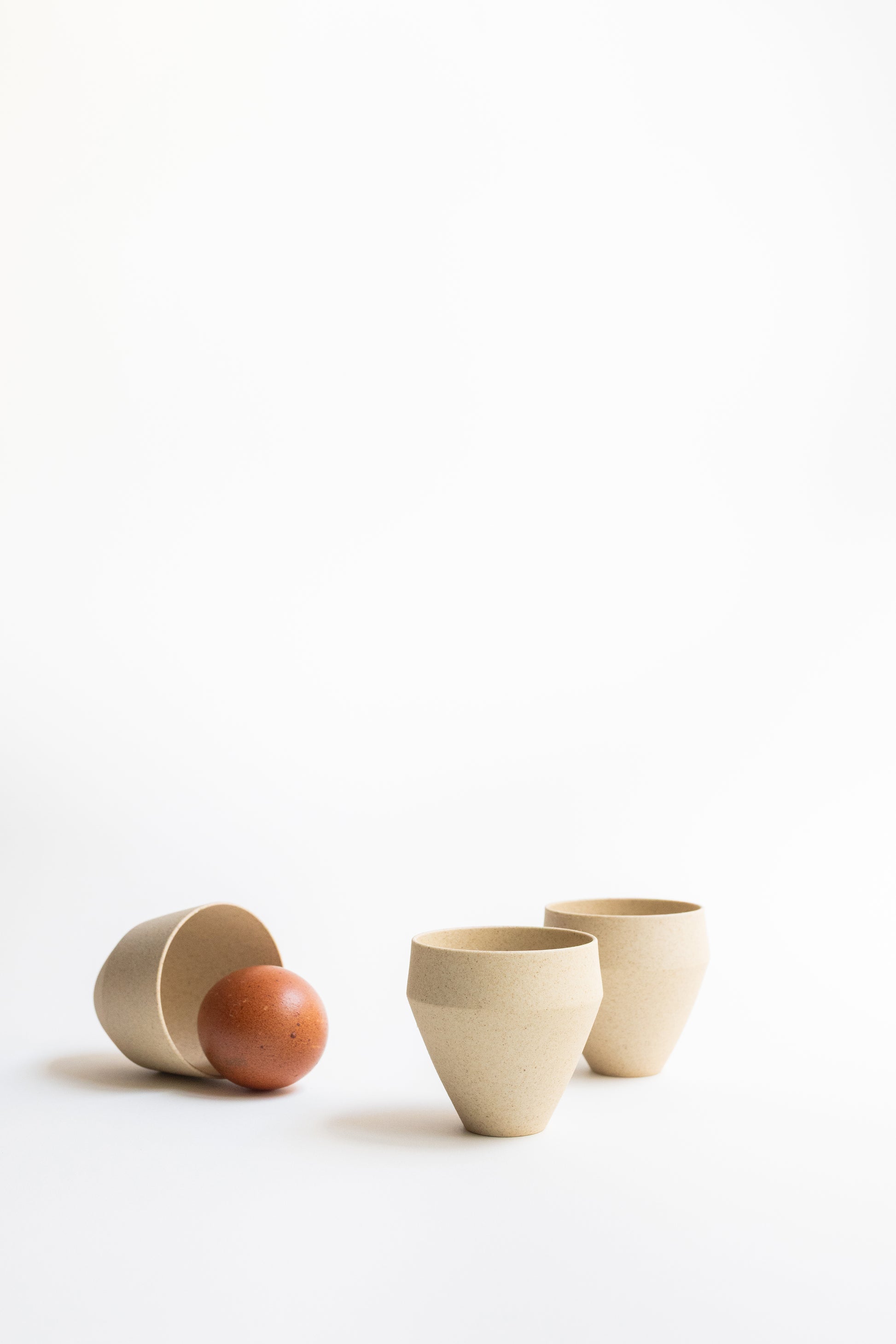Three ceramic cups on a white background