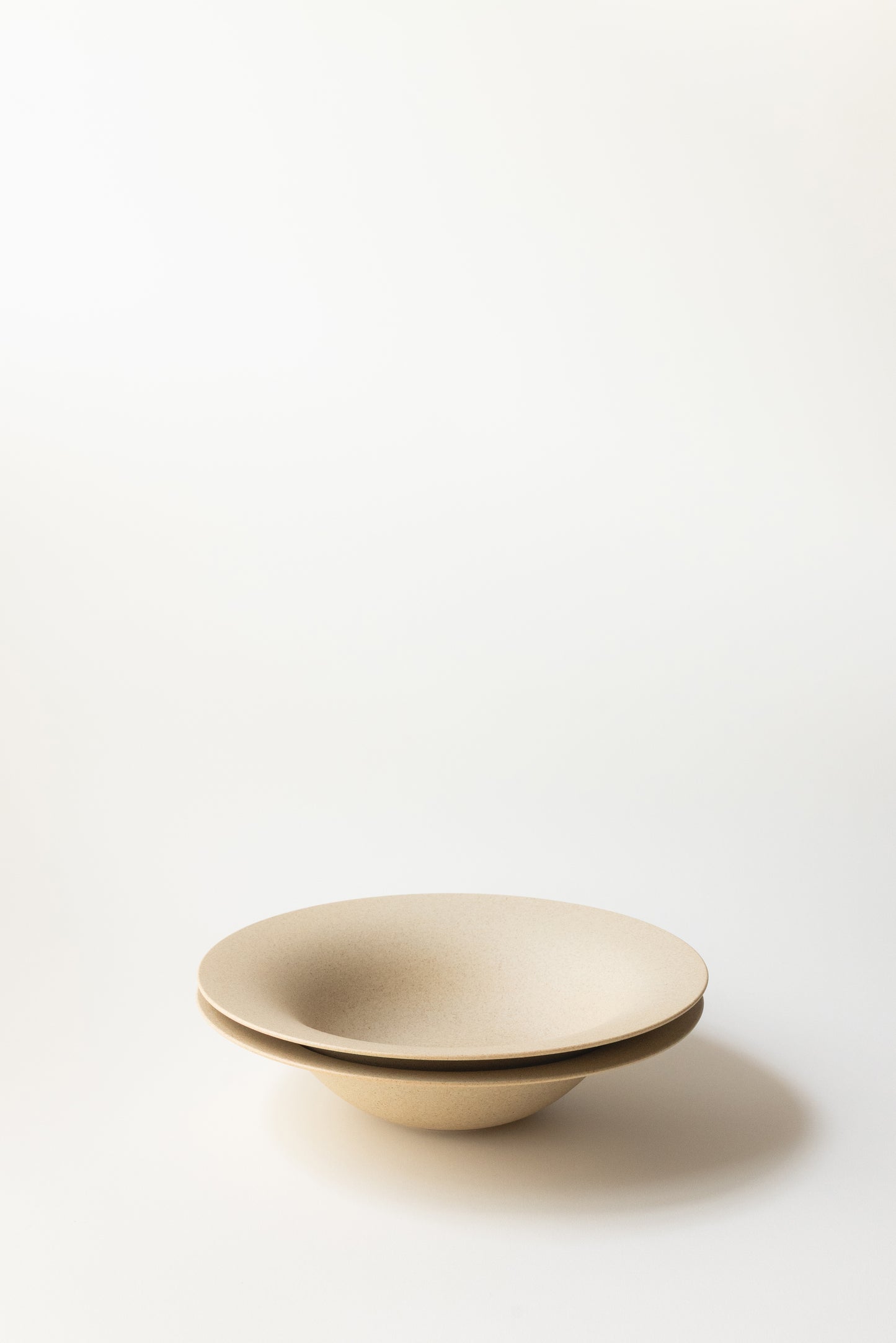 Beige ceramic bowl on a white background