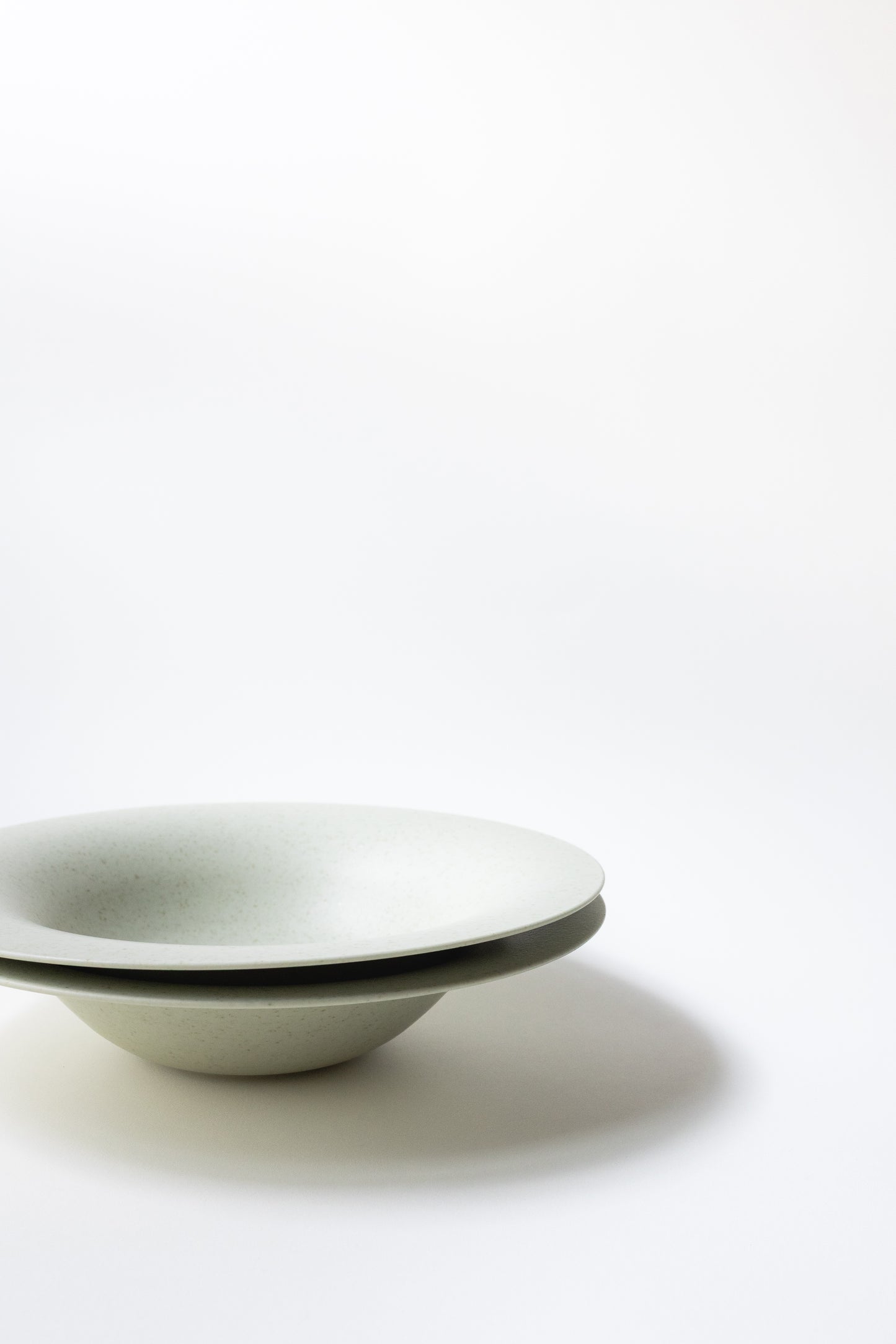 White ceramic bowl with black rim on a white background