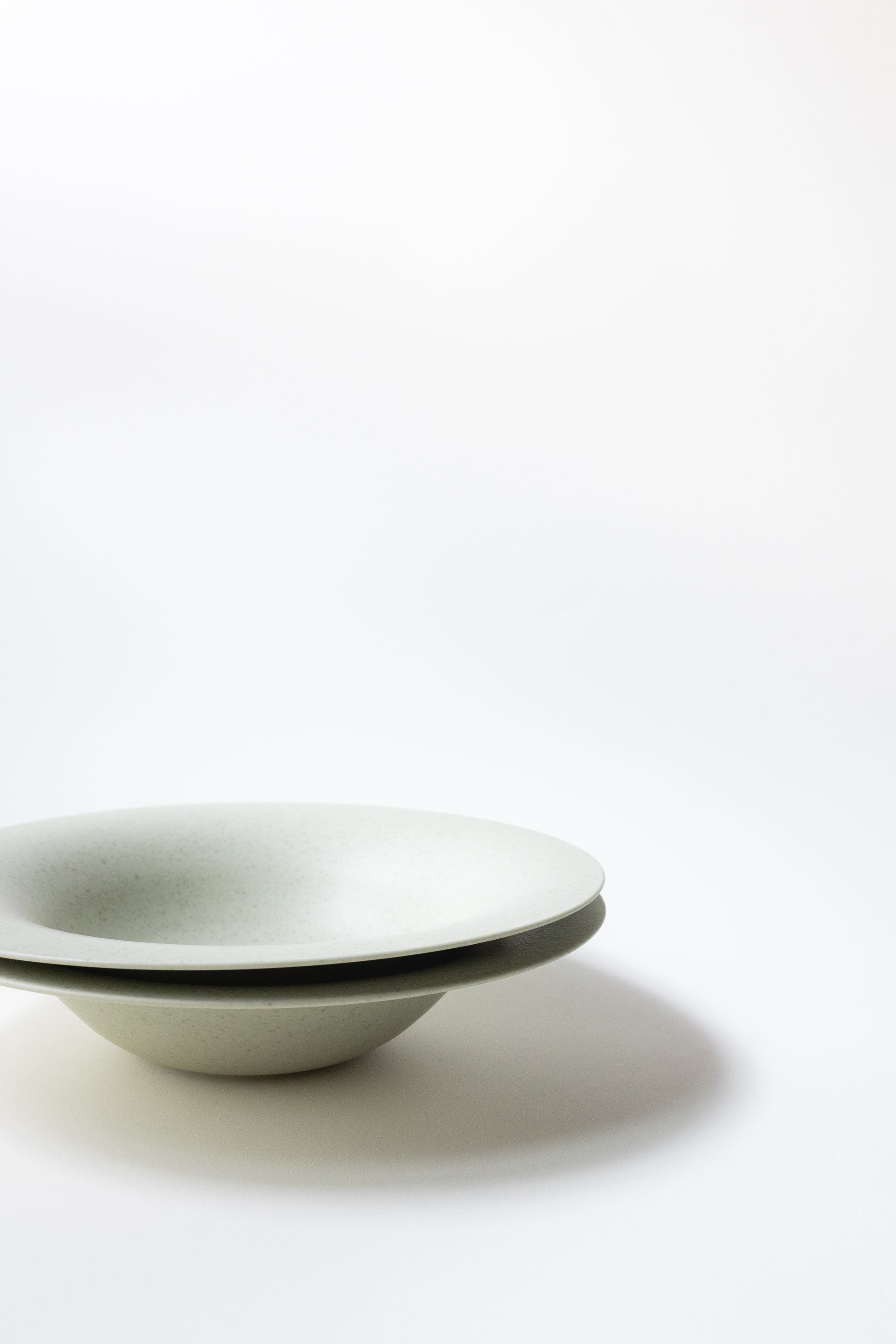 White ceramic bowl with black rim on a white background